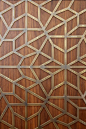 Detailed metal fret work laid over wood