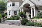 This is an example of a medium sized traditional front formal full sun garden for summer in New York with a garden path and natural stone paving.