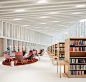 an empty library with chairs and bookshelves filled with lots of bookcases