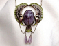 Circa 1920. This fantastic Egyptian revival Plique a jour necklace is centered by a bezel set oval scarab Amethyst . Surrounding this beautiful stone are the wings and tail of a mythical bird in beautiful green and purple plique a jour enamel. Dangling fr