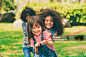 Happy children playing tug of war and having fun during summer camping in the park. Happy children playing tug of war and having fun during summer camping in the park. Children recreation concept. Child Stock Photo