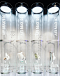 This may contain: three glass cases with toothbrushes and toothpaste on them in front of a black background