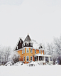 orange and gray concrete house surround by snow