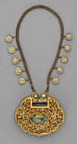 A gilt brass and silver necklace with a large pendant displaying the figures of Hehe Erxian, Buddhist lion-dogs, birds and flowers, the details inset with jade and tiny corals. The chain with round pendants displaying flower sprays and Chinese characters.