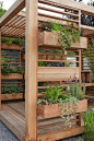 Pergola with vertical containers, another great way to extend a garden.