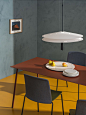 Red Aeeri dining table by Arper in a teal dining space with mustard yellow floor[主动设计米田整理]