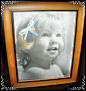 I found my baby girls first haircut curl in a scrapbook and attached it to a photo and framed it for her Birthday.