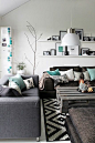 This modern and chic living room design is gorgeous. The charcoal and teal colour combination is sublime. Don't you think?