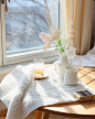 gvnfc_There_is_a_table_near_the_window_with_a_white_tablecloth__a4388dc1-07ef-4791-ac2b-93691e9a4e03