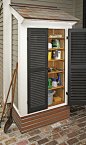 Outdoor shed with shutters built right next to the house: 