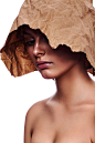 Young beauty woman Kraft paper red paint head face skin