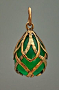 A highly unusual gold and chrysoprase egg pendant. Made in St. Petersburg between 1899 and 1904. An egg-shaped carved chrysoprase (the most valuable variety of chalcedony gemstones) of glowing green color is mounted with two-tone gold interlaced garlands.