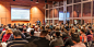 Business speaker giving a talk in conference hall. by Matej Kastelic on 500px