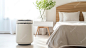 Air purifier in cozy white bedroom for filter and cleaning removing dust PM25 HEPA and virus in homefor fresh air and healthy Wellness life Generative ai