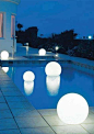 These floating light globes are a unconventional and stylish way to decorate your backyard.: 
