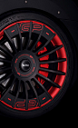 the wheel and tire of a car with red spokes