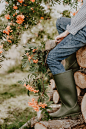 sitting person wearing black rain boots