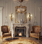 an ornate living room with two chairs and a fire place in the middle of the room