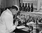 Side profile of a scientist looking through a microscope, Research Station, Bristol University, England