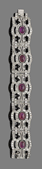 A ruby and diamond bracelet.  Composed of old brilliant and single-cut diamond openwork rectangular plaques, each collet-set to the centre with an oval cabochon ruby, millegrain-set throughout. Art Deco or Art Deco style.: 