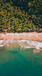 an aerial view of a sandy beach and ocean