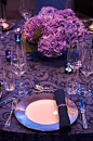 Purple wedding ideas. A dark purple table setting is accented with lighter purple hydrangea centerpieces.