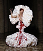 a woman in a white and red dress holding an umbrella