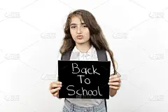 女学生看着镜头，带着回学校的课文。伤心的学生，因为学校开学了。教育理念背景，横幅，海报。