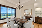Large arts and crafts medium tone wood floor and tray ceiling enclosed dining room photo in Denver with white walls