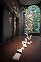 A Gust of Wind by Pauls Cocksedge is an installation of 300 sheets of corian engraved with the words "Idea Tray" and a series number and suspended like sheets of falling paper at the Victoria & Albert Museum for the London Design Festival an