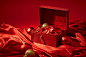 A red open box on a red background with golden ornaments., in the style of carl kleiner, crumpled, anne geddes, commission for, photorealistic compositions, xmaspunk, installation creator