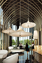 Low hanging lights from a high ceiling are all the rage and are becoming more and more popular. Especially in lobbies. I believe it's because when we look to the ceiling and see the lights we can't see the ceiling but we can sense the echoes so it feels l