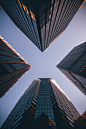 low-angle photography of four high-rise buildings