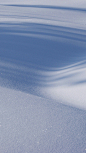This may contain: a person riding skis down a snow covered slope in the middle of the day
