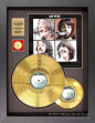 A commemorative set of Beatles gold records gets an update with a chunky black frame to replace a small and dated looking frame in our client's collection.: