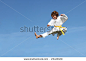 (SOME MOTION BLUR)Karate kid doing karate kick - stock photo