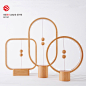 Heng : HENG is a serious of lamps breaking the traditional way to turn on lamps. The two balls in the wooden frames serve as switches of the lamps. As we raise the the lower ball, the two balls would be drawn together magnetically. They would float in the