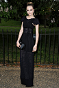 Wearing a Chanel gown and carrying a Chanel clutch - with her hair styled in a neat topknot - at the Serpentine Summer party.