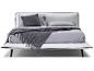 Puima king bed in off-white leather and grey fabric.