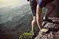 success young woman rock climber on mountain peak