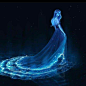 a woman in a blue dress is floating on the water with her hair blowing back