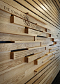 Environmental graphics by Chad Evans, timber slatted cladding with text printed onto the surface