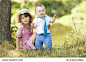 a little brother and sister playing on the nature