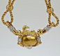 A bespoke Chaumet collar necklace.

With a pendant and yoke in gold and platinum suspended by a double rope chain.

The pendant features a textured domed plaque offset with a thin platinum band set in a scrolled setting together with 11 very fine