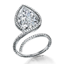 Centering a pear-shaped diamond weighing 5.04 carats, with additional pavé set diamonds. Mounted in platinum.