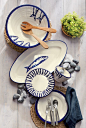 A life by the sea inspired our exclusive terra cotta tableware collection designed by a master Portuguese ceramicist. Variations on striking fish icons are hand painted in deep blue on creamy-glazed backgrounds with freeform rims. The elongated oval platt