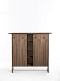 Tamok Madia : Cupboard in canaletta walnut with top in wood, marble or Rock and solid canaletta walnut edges. Equipped with two compartments with hinged doors. In the left compartment there is a drawer with two clear glass shelves, while the right compart