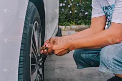 人们在给汽车轮胎充气