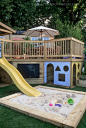 playhouse built under porch with slide into sandbox