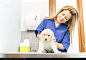 Veterinary checking a dog puppie in her studio - stock photo